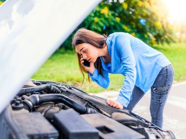 Woman Checking Her Car's Engine