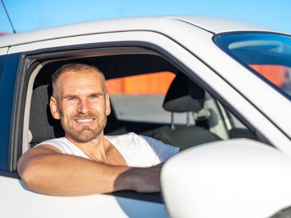 Man Driving a White Car