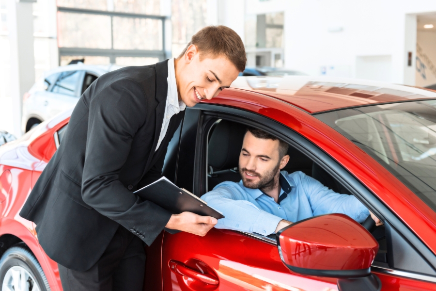 Man Driving a Red Car