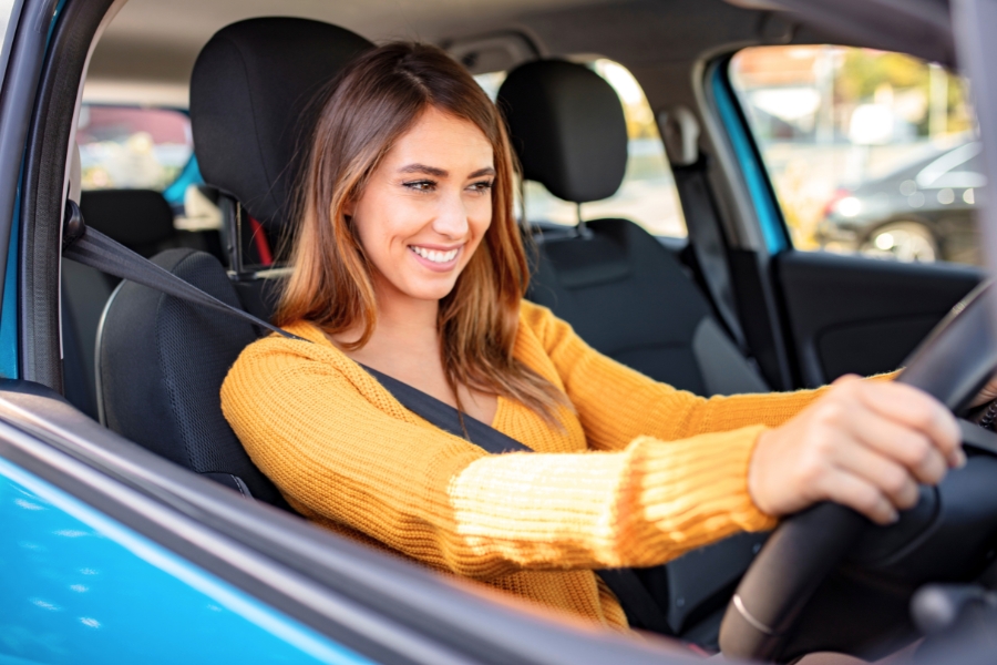 Woman Driving a Blue Car