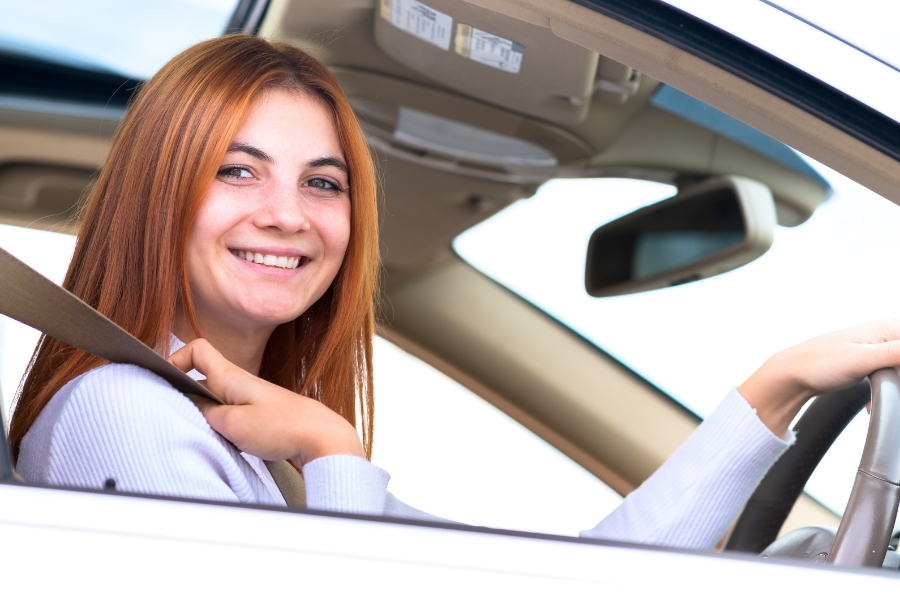 Woman Driving a White Car