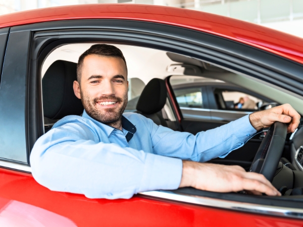 Man Driving a Red Car
