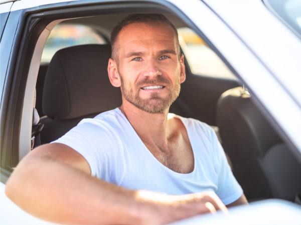 Man Driving a White Car