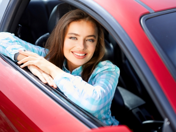 Woman Driving a Red Car