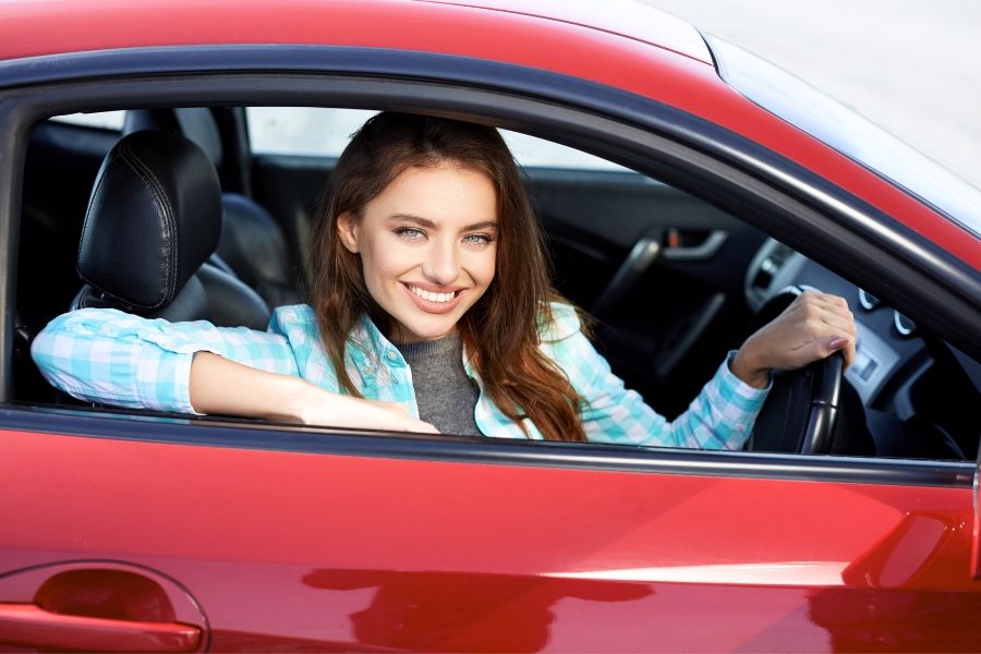 Woman Driving a Red Car