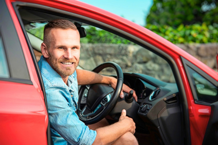 Man Driving a Red Car